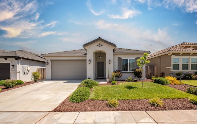 511 Timberline Way S, Madera, CA 93636 - mediterranean / spanish home with stucco siding, an attached garage, driveway, and a front lawn