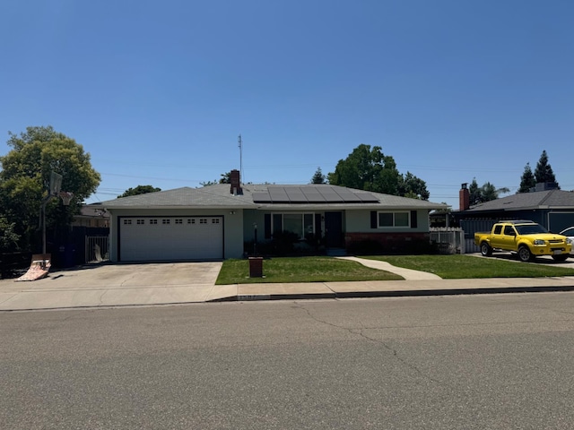 1507 2nd St, Sanger, CA 93657 - ranch-style house with a garage, driveway, and solar panels