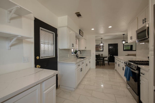 168 E Stuart Ave, Fresno, CA 93710 - kitchen with appliances with stainless steel finishes, recessed lighting, a sink, backsplash, and white cabinetry