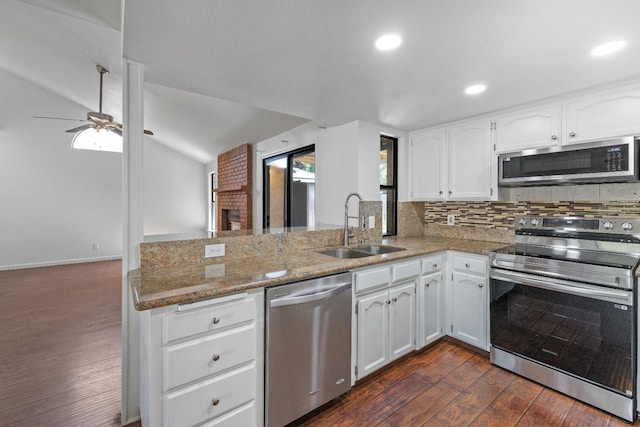 6546 N Bendel Ave, Fresno, CA 93722 - kitchen with stainless steel appliances, a sink, dark wood-type flooring, a peninsula, and light stone counters