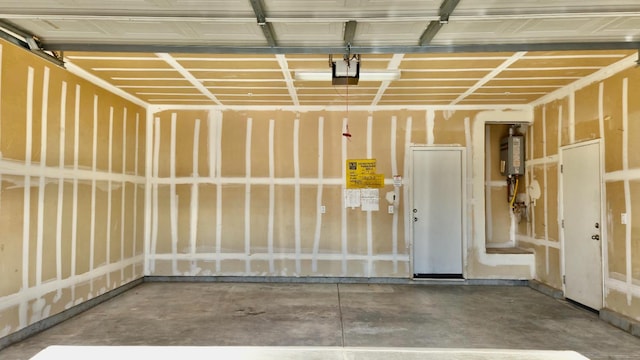 758 Persimmon, Madera, CA 93638 - garage featuring water heater and a garage door opener