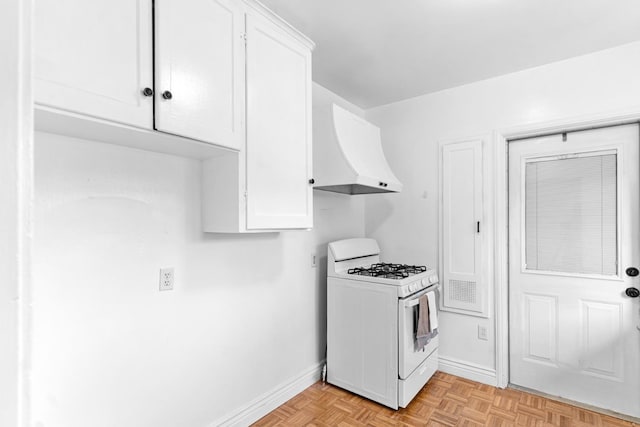 3446 E Lamona Ave, Fresno, CA 93703 - kitchen with white gas range oven, custom exhaust hood, and white cabinets