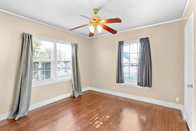 3446 E Lamona Ave, Fresno, CA 93703 - empty room with healthy amount of natural light, a ceiling fan, wood finished floors, and ornamental molding