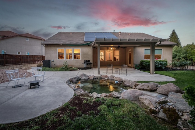 3126 San Gabriel Ave, Clovis, CA 93619 - rear view of property featuring a ceiling fan, a patio, a tiled roof, roof mounted solar panels, and a fenced backyard