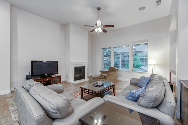 3126 San Gabriel Ave, Clovis, CA 93619 - living room featuring ceiling fan, baseboards, and a glass covered fireplace