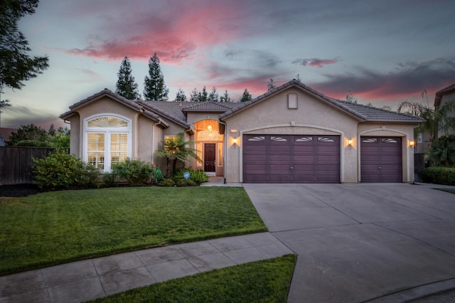 3126 San Gabriel Ave, Clovis, CA 93619 - mediterranean / spanish house featuring stucco siding, a garage, driveway, and a tiled roof