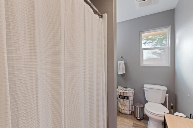 2724 Monocott Dr, Madera, CA 93637 - bathroom with toilet, wood finished floors, and curtained shower