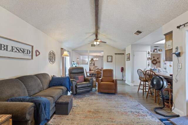 2724 Monocott Dr, Madera, CA 93637 - living room with wood finished floors, a ceiling fan, a textured ceiling, lofted ceiling, and a chandelier