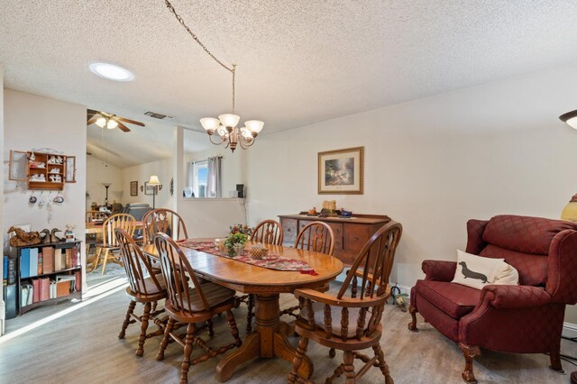 2724 Monocott Dr, Madera, CA 93637 - dining space featuring wood finished floors, a textured ceiling, a chandelier, vaulted ceiling, and ceiling fan