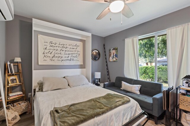 2724 Monocott Dr, Madera, CA 93637 - bedroom featuring a wall mounted AC, wood finished floors, and a ceiling fan