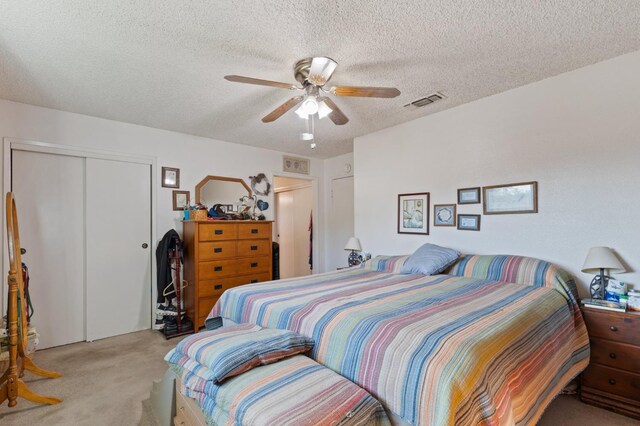 2724 Monocott Dr, Madera, CA 93637 - bedroom featuring light carpet, a closet, a textured ceiling, and a ceiling fan
