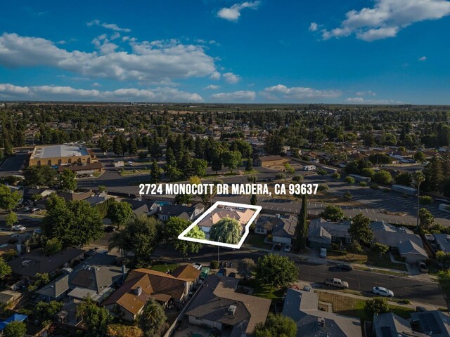 2724 Monocott Dr, Madera, CA 93637 - aerial view of property and surrounding area with property parcel outlined and nearby suburban area