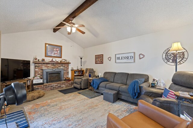 2724 Monocott Dr, Madera, CA 93637 - living room featuring a ceiling fan, wood finished floors, a textured ceiling, and a brick fireplace