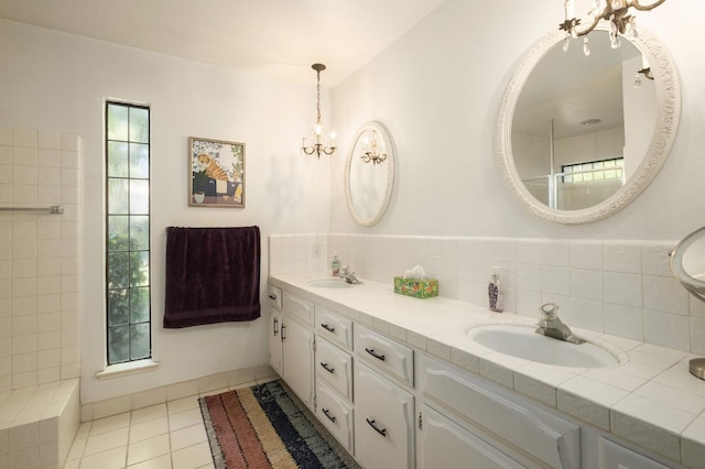 2063 W Barstow Ave, Fresno, CA 93711 - full bathroom with double vanity, a chandelier, tile patterned flooring, and decorative backsplash