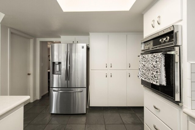 2063 W Barstow Ave, Fresno, CA 93711 - kitchen featuring stainless steel fridge with ice dispenser, wall oven, dark tile patterned flooring, white cabinetry, and light countertops