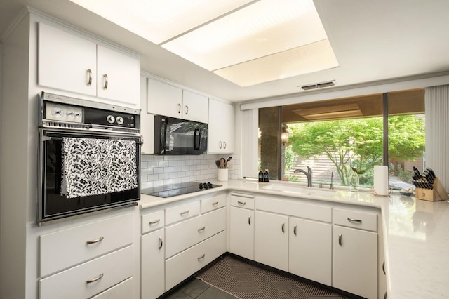 2063 W Barstow Ave, Fresno, CA 93711 - kitchen featuring black appliances, a sink, decorative backsplash, and light countertops