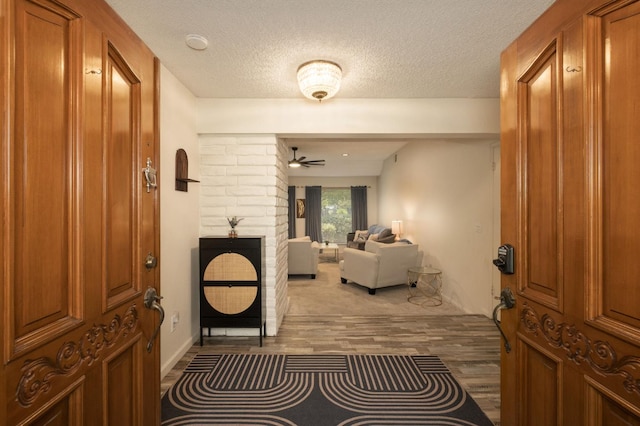 2063 W Barstow Ave, Fresno, CA 93711 - foyer entrance with wood finished floors, a ceiling fan, and a textured ceiling
