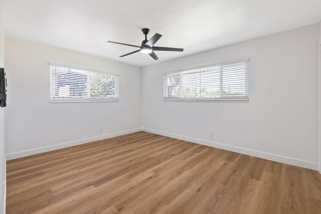 5075 N College Ave, Fresno, CA 93704 - empty room featuring healthy amount of natural light, baseboards, and light wood-type flooring