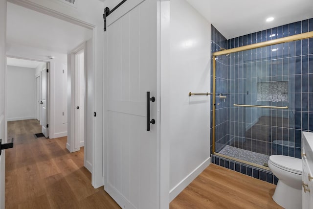 5075 N College Ave, Fresno, CA 93704 - full bath featuring a shower stall, wood finished floors, toilet, and baseboards