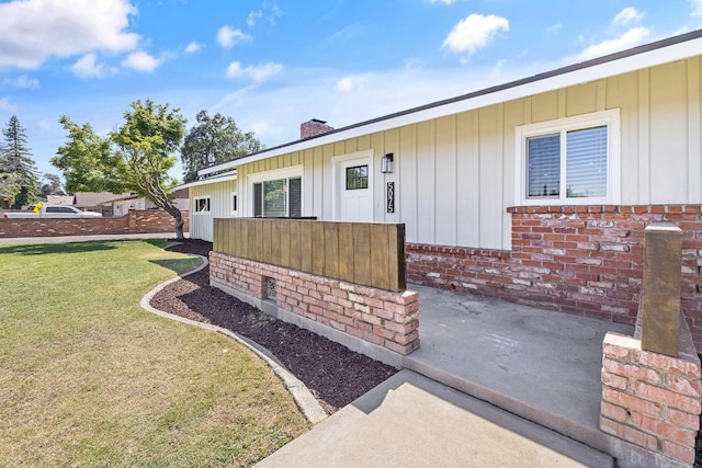 5075 N College Ave, Fresno, CA 93704 - property entrance featuring board and batten siding, brick siding, and a chimney