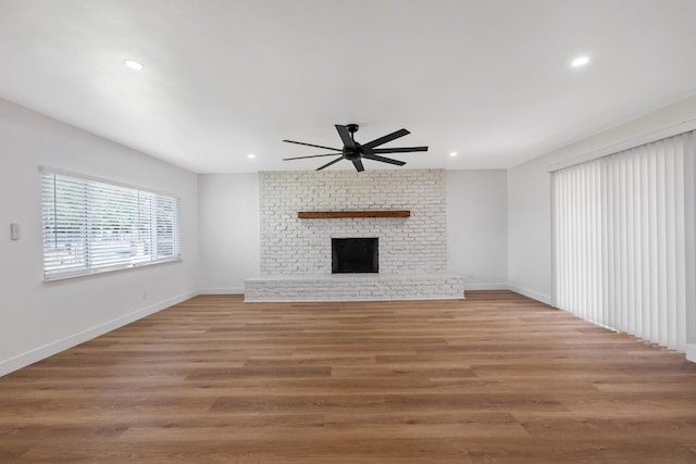 5075 N College Ave, Fresno, CA 93704 - unfurnished living room with ceiling fan, recessed lighting, baseboards, light wood-style flooring, and a brick fireplace