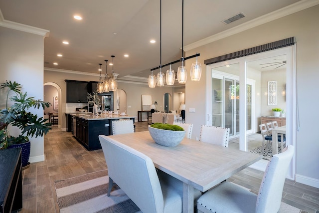 3343 Richmond Ave, Clovis, CA 93619 - dining area with arched walkways, recessed lighting, crown molding, wood finished floors, and baseboards