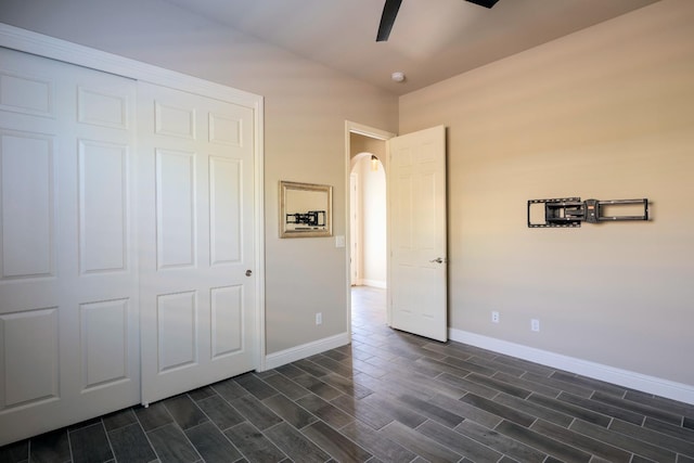 3343 Richmond Ave, Clovis, CA 93619 - unfurnished bedroom featuring arched walkways, baseboards, and dark wood-style floors