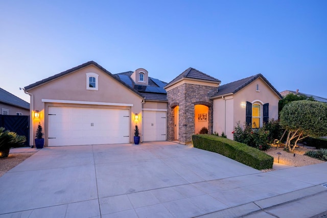 3343 Richmond Ave, Clovis, CA 93619 - french country style house with stucco siding, an attached garage, stone siding, and driveway