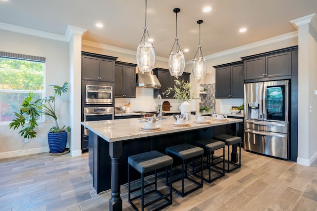 3343 Richmond Ave, Clovis, CA 93619 - kitchen with stainless steel fridge with ice dispenser, light stone counters, decorative backsplash, a breakfast bar, and wall chimney range hood