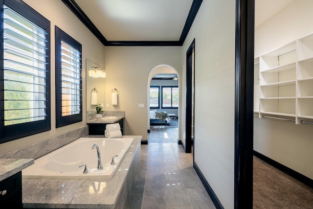 3343 Richmond Ave, Clovis, CA 93619 - ensuite bathroom with ornamental molding, vanity, a garden tub, baseboards, and tile patterned flooring