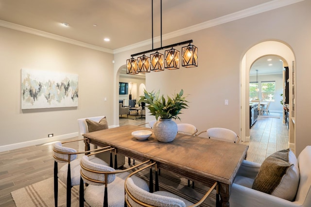 3343 Richmond Ave, Clovis, CA 93619 - dining area with arched walkways, crown molding, light wood finished floors, baseboards, and recessed lighting