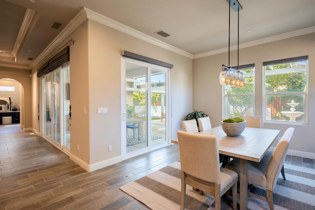 3343 Richmond Ave, Clovis, CA 93619 - dining space with arched walkways, crown molding, baseboards, and wood finished floors