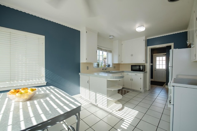 2837 N Thorne Ave, Fresno, CA 93704 - kitchen with black microwave, freestanding refrigerator, stove, and plenty of natural light