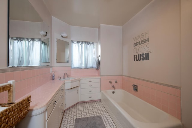 2837 N Thorne Ave, Fresno, CA 93704 - full bathroom with vanity, a garden tub, tile patterned flooring, and tile walls