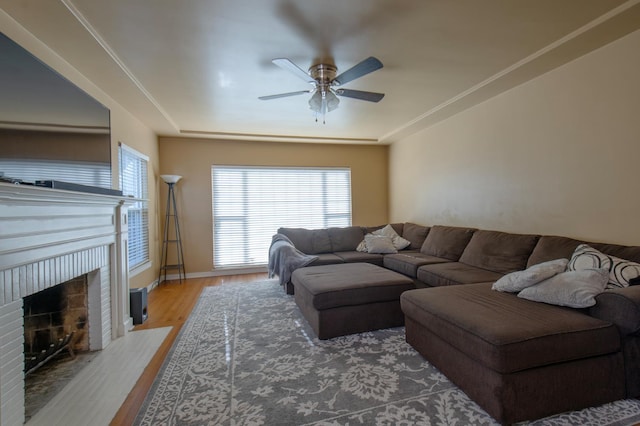 2837 N Thorne Ave, Fresno, CA 93704 - living room with ceiling fan, wood finished floors, a fireplace, and baseboards