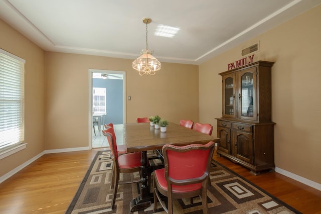 2837 N Thorne Ave, Fresno, CA 93704 - dining room with healthy amount of natural light, light wood-type flooring, and a chandelier
