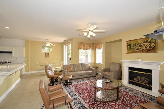 1756 N Holly Ave, Clovis, CA 93619 - living room with a ceiling fan, a glass covered fireplace, light tile patterned floors, and baseboards