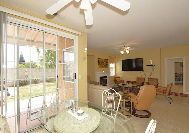 1756 N Holly Ave, Clovis, CA 93619 - tiled dining area with ceiling fan and a glass covered fireplace