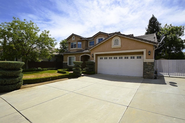 1756 N Holly Ave, Clovis, CA 93619 - view of front of home featuring stone siding, driveway, stucco siding, an attached garage, and a gate