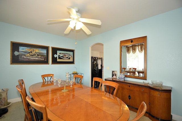 1756 N Holly Ave, Clovis, CA 93619 - dining room with arched walkways, a ceiling fan, light tile patterned floors, and baseboards
