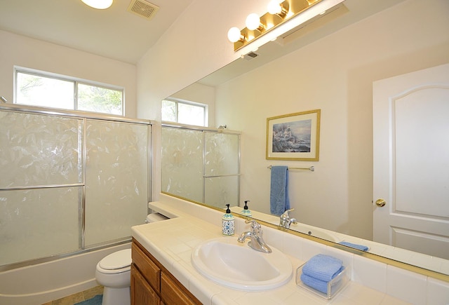 1756 N Holly Ave, Clovis, CA 93619 - bathroom featuring vanity, toilet, and bath / shower combo with glass door