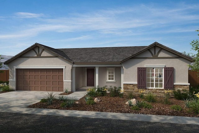 2266 S Sylmar, Fresno, CA 93725 - view of front of home featuring stucco siding, stone siding, concrete driveway, and a garage