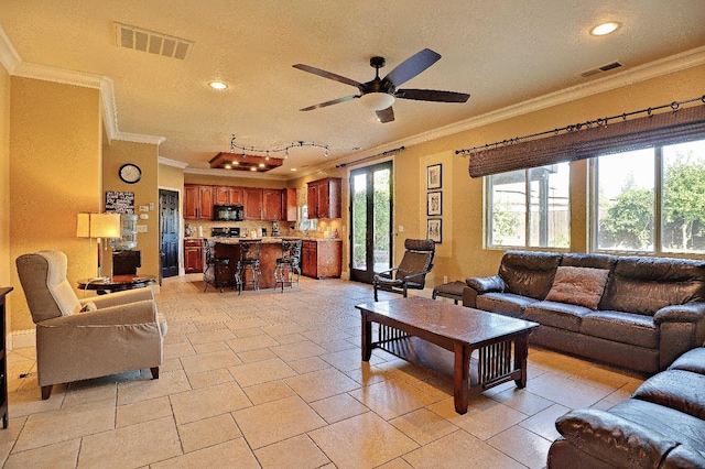 3356 N Burgan Ave, Fresno, CA 93727 - living area with ornamental molding, a ceiling fan, recessed lighting, and a textured ceiling
