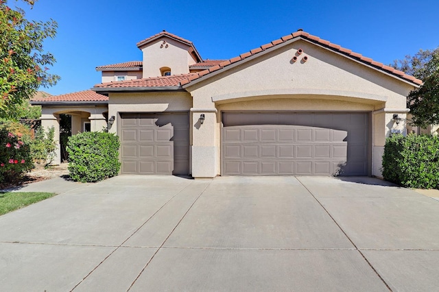 3356 N Burgan Ave, Fresno, CA 93727 - mediterranean / spanish house with an attached garage, stucco siding, a tiled roof, and driveway