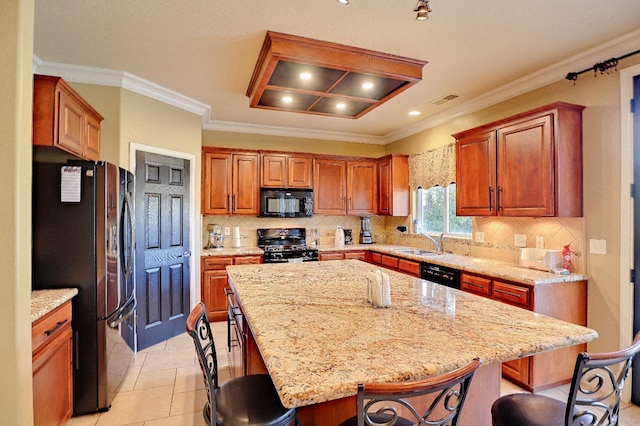 3356 N Burgan Ave, Fresno, CA 93727 - kitchen featuring black appliances, a kitchen breakfast bar, light stone countertops, and crown molding