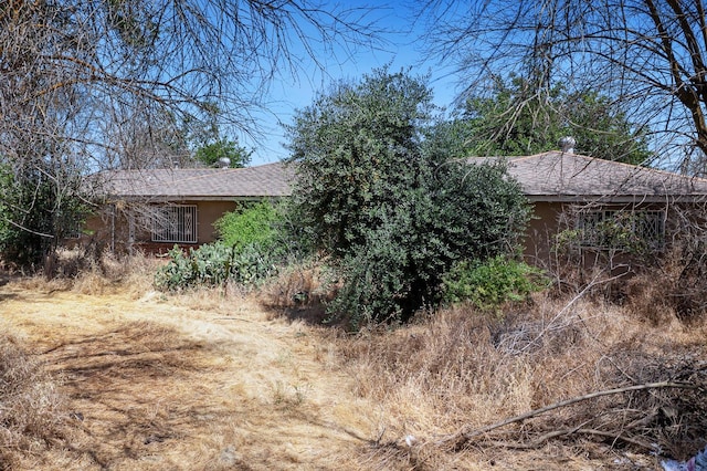 8574 E Herndon Ave, Clovis, CA 93619 - view of side of property with a shingled roof and stucco siding