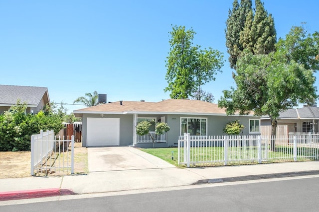 3856 E Harvard Ave, Fresno, CA 93703 - single story home with stucco siding, a garage, and driveway