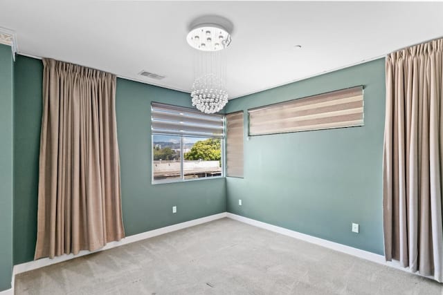 977 24th St, Oakland, CA 94607 - carpeted empty room with a chandelier and baseboards