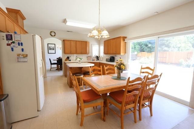1976 Decatur Ave, Clovis, CA 93611 - dining space with arched walkways and a chandelier