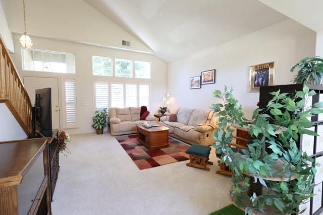 1976 Decatur Ave, Clovis, CA 93611 - carpeted living area with high vaulted ceiling and stairway